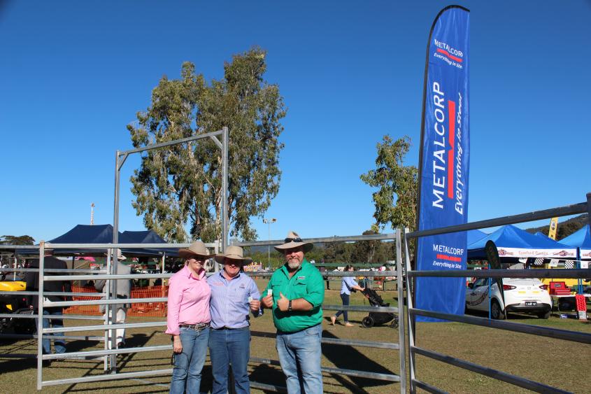 three people posting for a photo outdoors